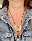 Model wearing large jeweler's brass crescent leaf necklace, handfabricated nature jewelry