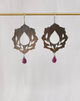 Ride with Me sterling silver pierced botanical dangle earrings with ruby droplet, hanging on brass display bar