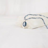 Blue kyanite cabochon pendant necklace with aquamarine beaded strand, front facing view