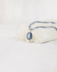 Blue kyanite cabochon pendant necklace with aquamarine beaded strand, front facing view