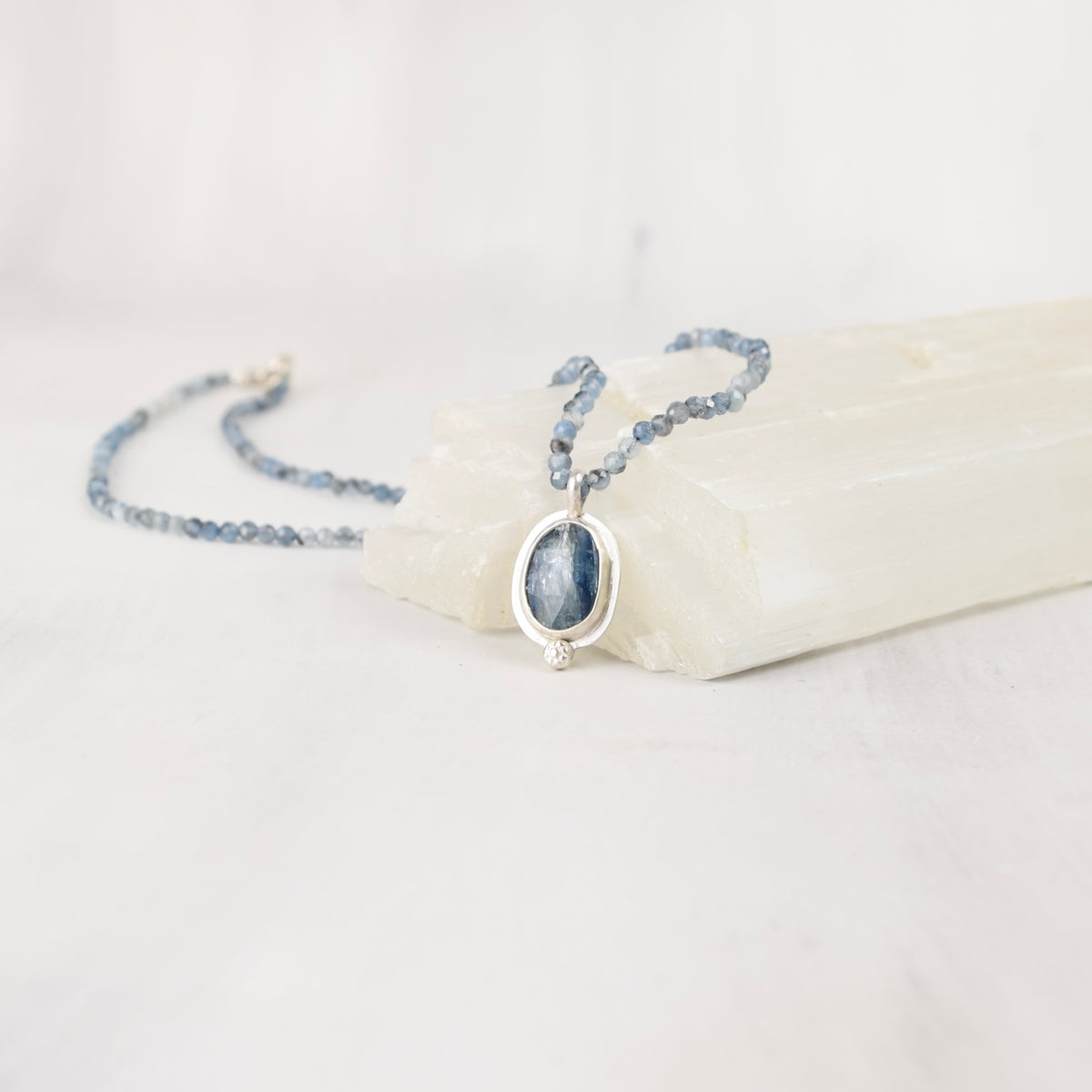 Handmade sterling silver necklace with faceted blue kyanite and aquamarine beads, close front view