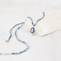 Close-up of faceted oval blue kyanite cabochon set in sterling silver