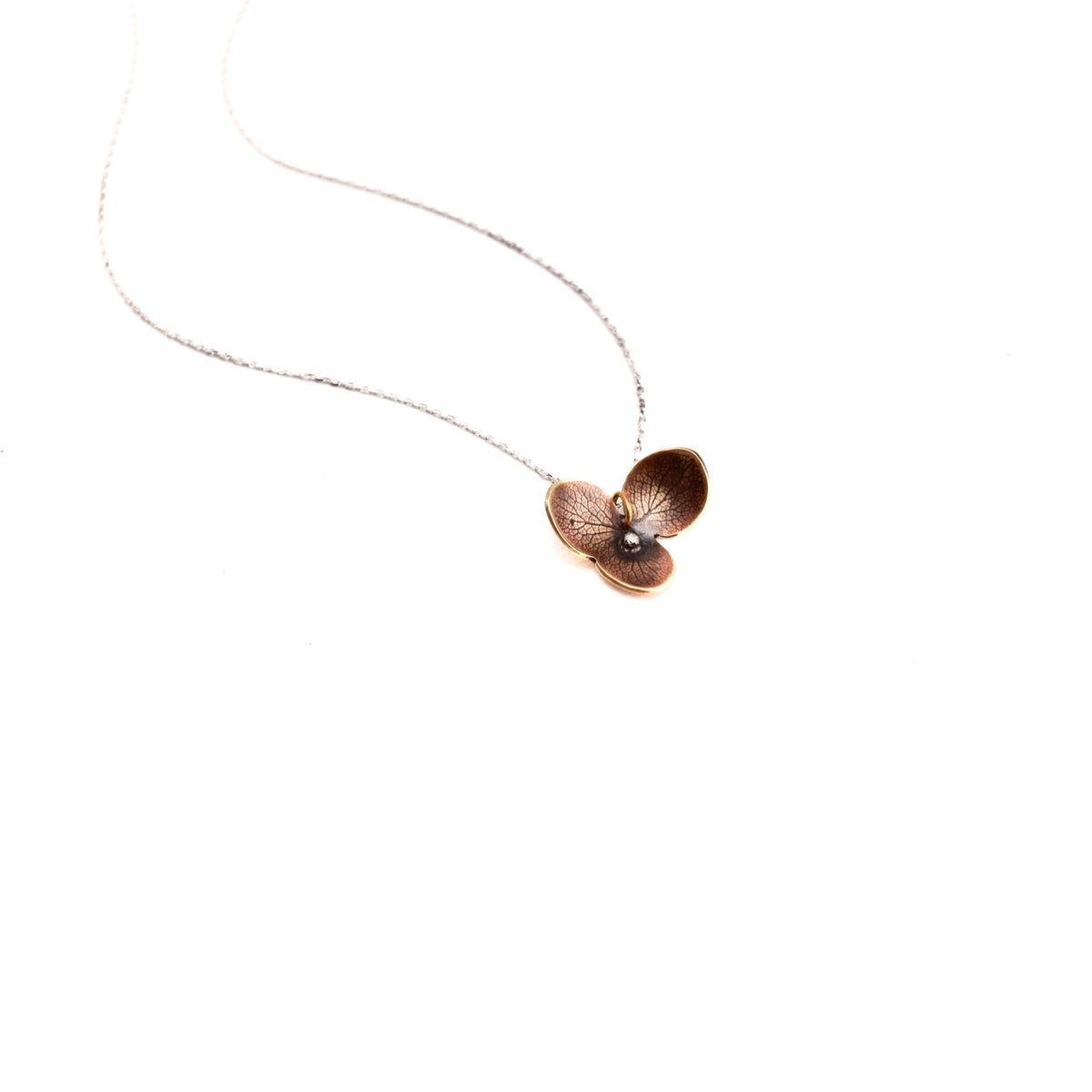 Jeweler's brass hydrangea bloom impression pendant necklace with sterling silver center on delicate sterling silver chain, handmade botanical jewelry crafted in Vermont