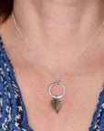  Model wearing graduated mixed metal leaf necklace on 18 inch sterling silver chain