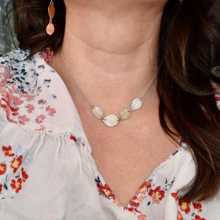 Model wearing handmade sterling silver hydrangea petal impression choker necklace, delicate botanical bridal jewelry handcrafted in Vermont