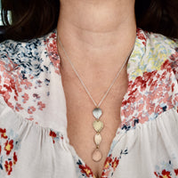 Model wearing handmade hydrangea petal ombré pendant necklace in sterling silver brass bronze and copper, artisan botanical nature jewelry crafted in Vermont