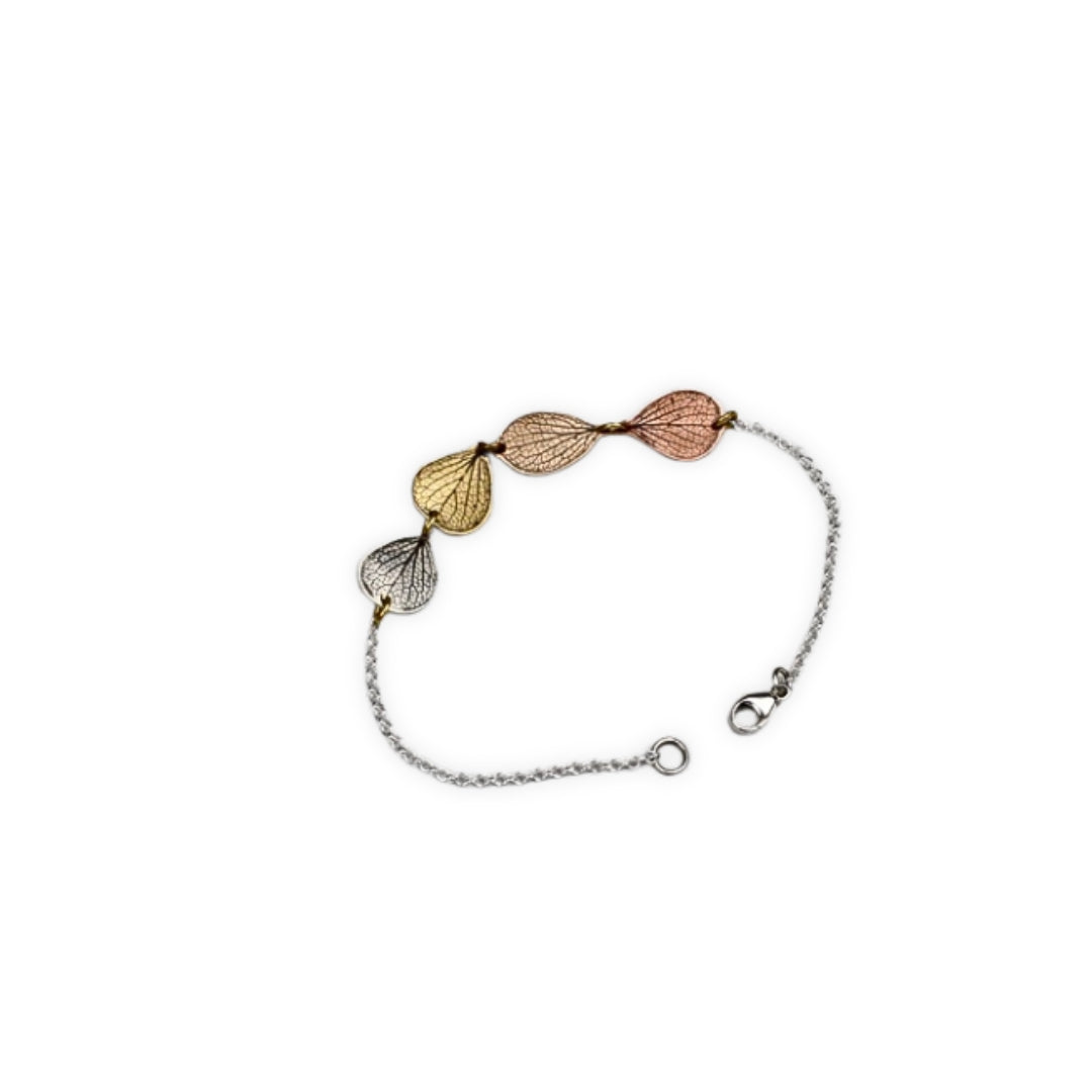 Overhead view of handmade hydrangea petal ombré bracelet in sterling silver, jeweler's brass, bronze and copper, botanical jewelry crafted in Vermont