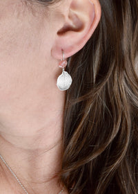 Model wearing handmade sterling silver hydrangea petal impression earrings with rose quartz, artisan botanical gemstone jewelry handcrafted in Vermont