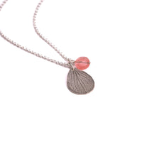 Overhead view of handmade sterling silver hydrangea petal impression necklace with faceted rose quartz bead, botanical gemstone jewelry crafted in Vermont