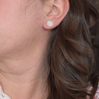 Model wearing handmade sterling silver hydrangea petal impression stud earrings, delicate floral jewelry handcrafted in Vermont