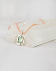 Close-up of bright polish sterling silver setting around a mint green kyanite gemstone pendant