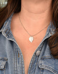 Model wearing delicate sterling silver botanical leaf necklace, handmade nature jewelry with real leaf impression, handcrafted in Vermont