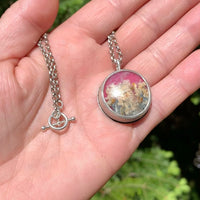 Close up of one of a kind handmade sterling silver pink plume agate necklace in hammered bezel setting, artisan gemstone jewelry crafted in Vermont