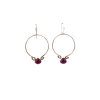 Front view of handmade sterling silver 30mm hoop earrings with genuine ruby briolette and brass wire wrapping, artisan gemstone jewelry crafted in Vermont