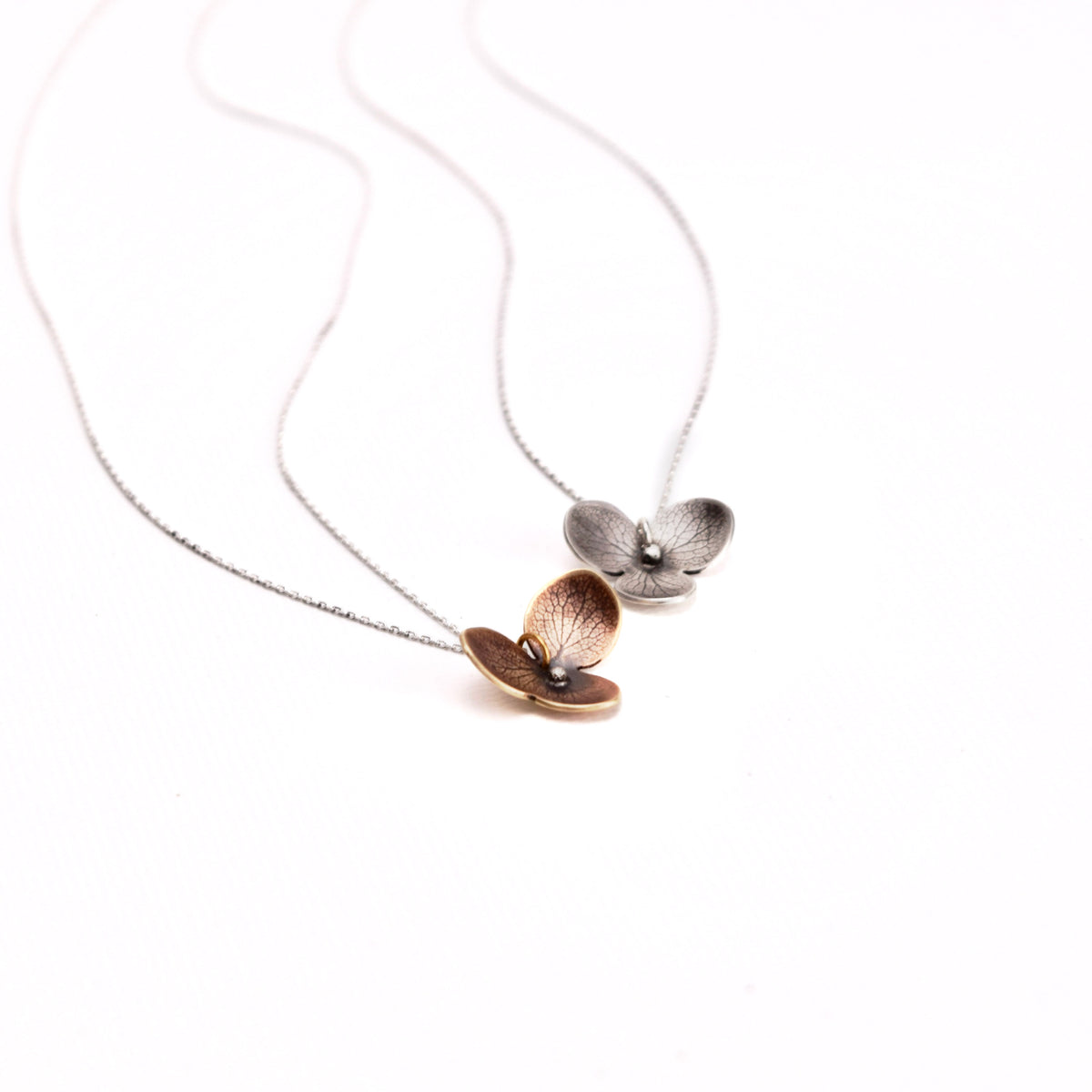 Handmade sterling silver and jeweler's brass hydrangea flower impression pendant necklaces on 18" sterling silver chain, crafted in Vermont