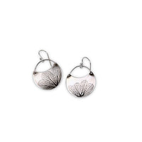 Overhead view of small handmade sterling silver hydrangea flower impression crescent dangle earrings, botanical jewelry crafted in Vermont