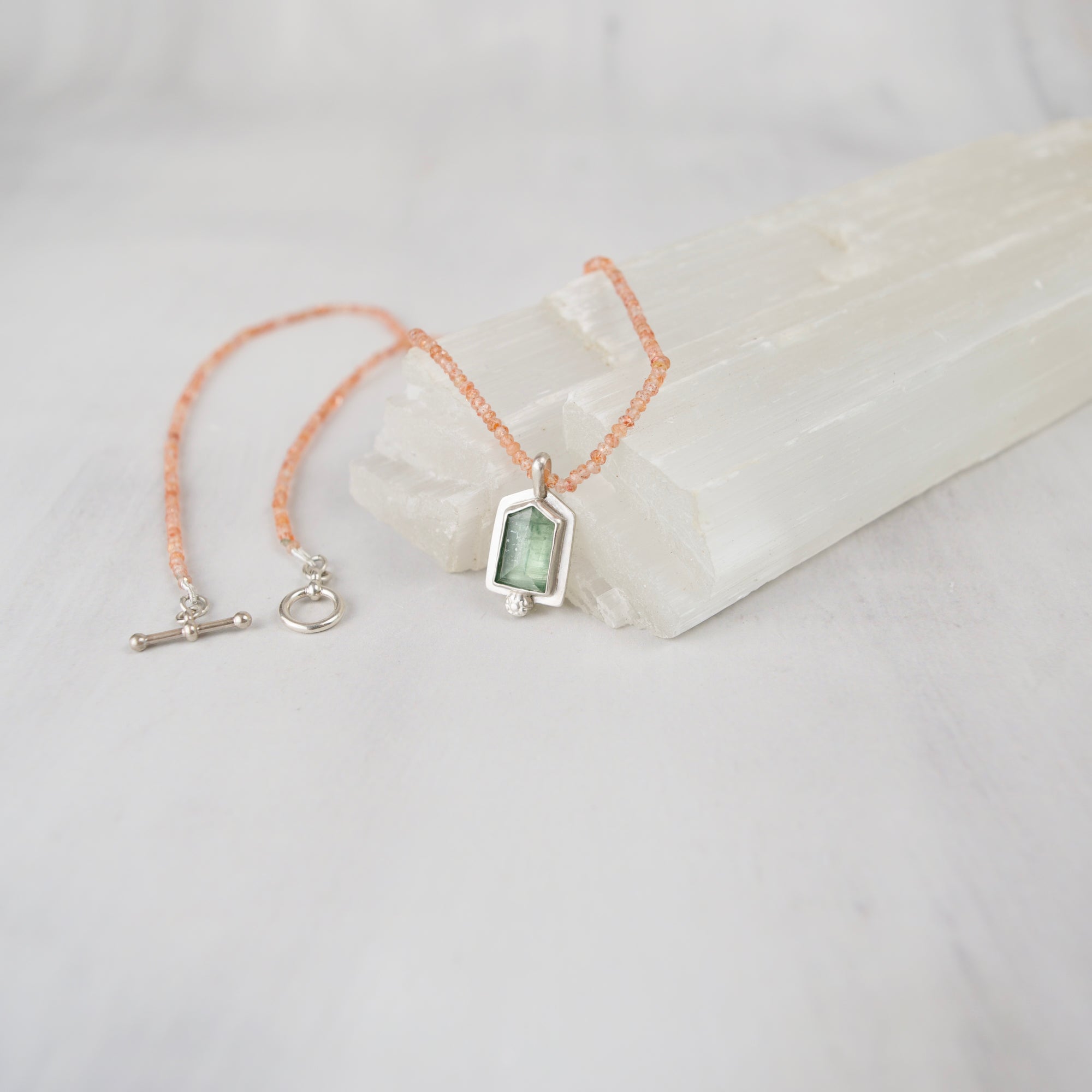 AAA grade sunstone rondelle beads strung on silk, 18 inch necklace with sterling silver toggle clasp